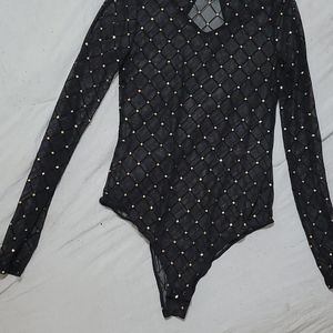 Sheer black bodysuit with gold accents